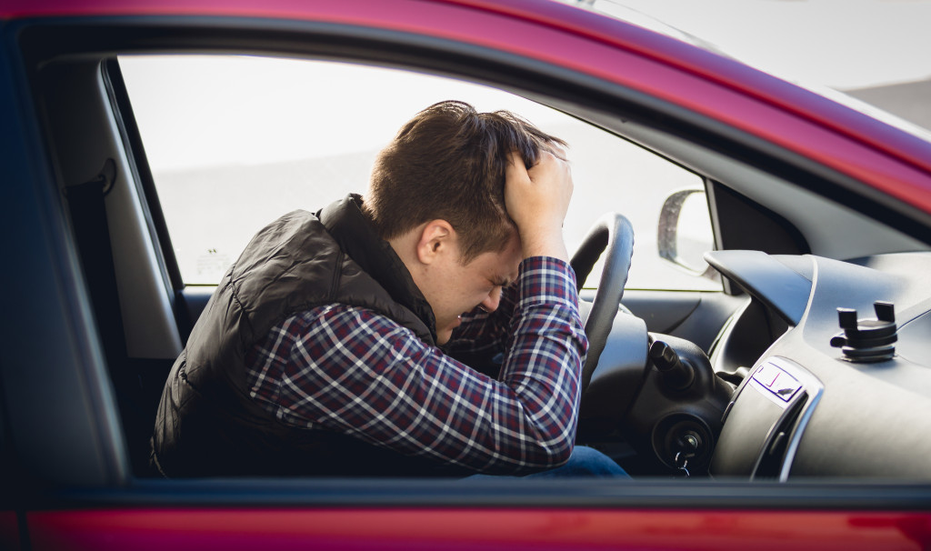 Closeup portrait of depressed man driving car ** Note: Soft Focus at 100%, best at smaller sizes